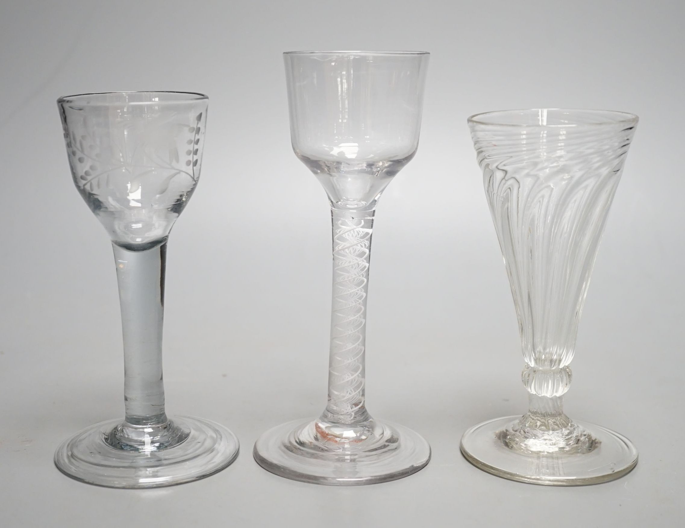 A George III opaque twist stem cordial glass, a George II cordial glass with folded foot and a wrythen twist ale glass (3) - tallest 15cm